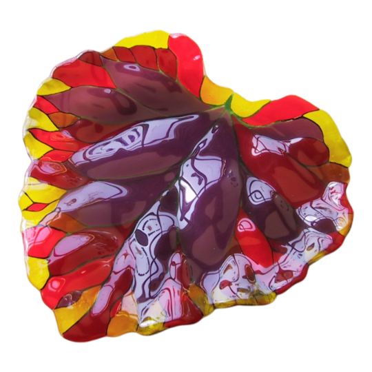 a multicolored (purple, red, yellow orange) decorative art glass piece in the shape of a very large leaf with intricate details forming the veins